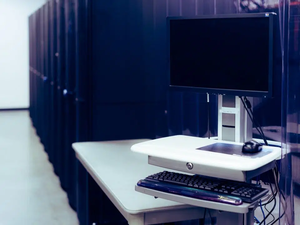 modern computer placed near server racks